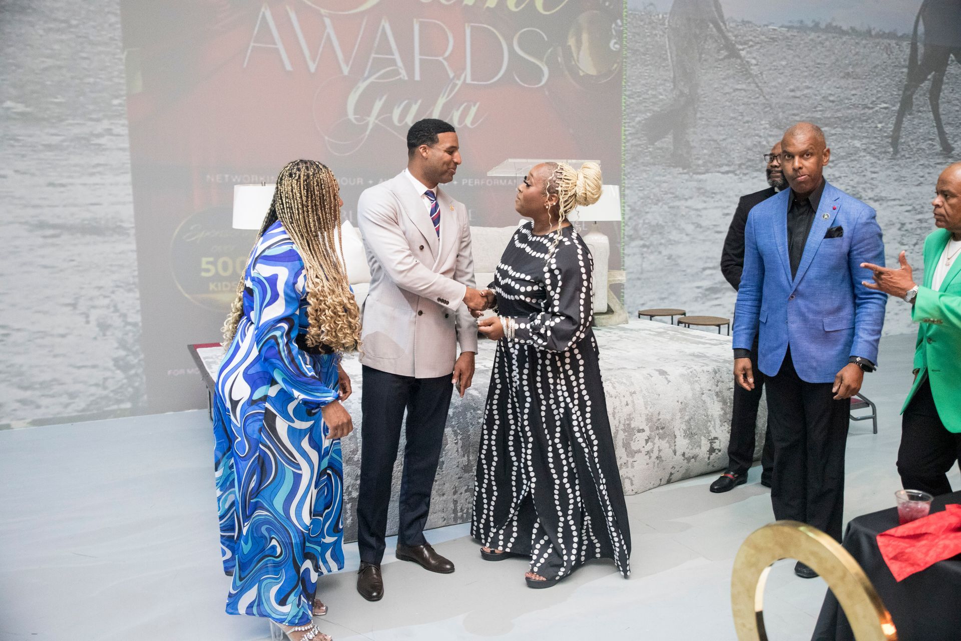 A group of people are shaking hands at an event.