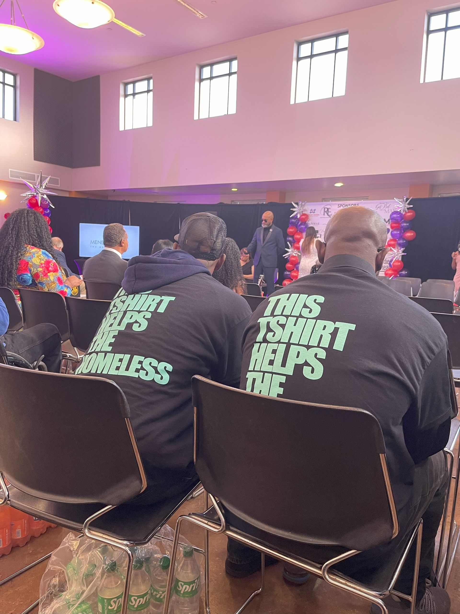 A group of people are sitting in chairs in a room.