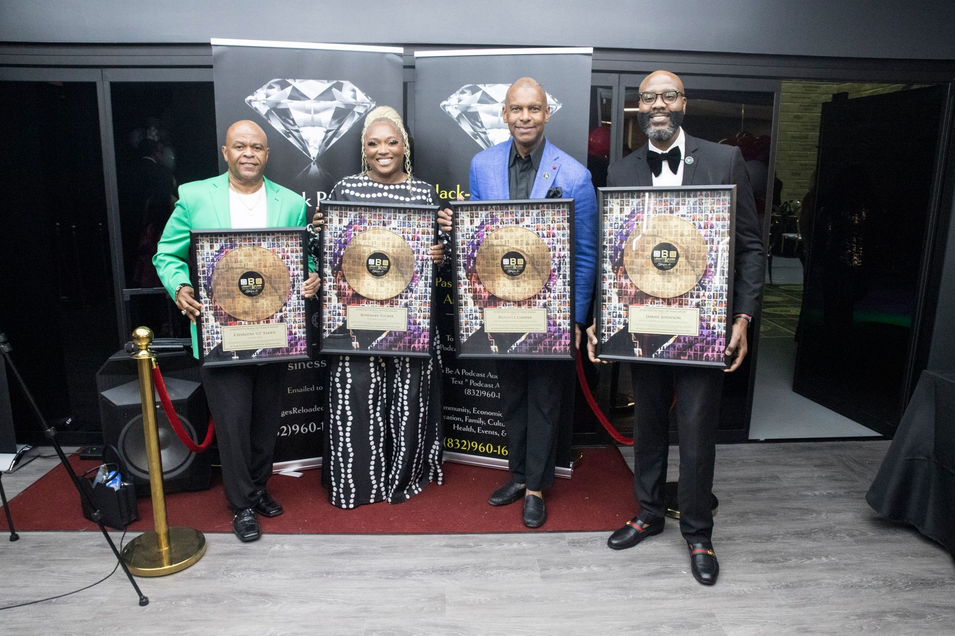 A group of people standing next to each other holding plaques.