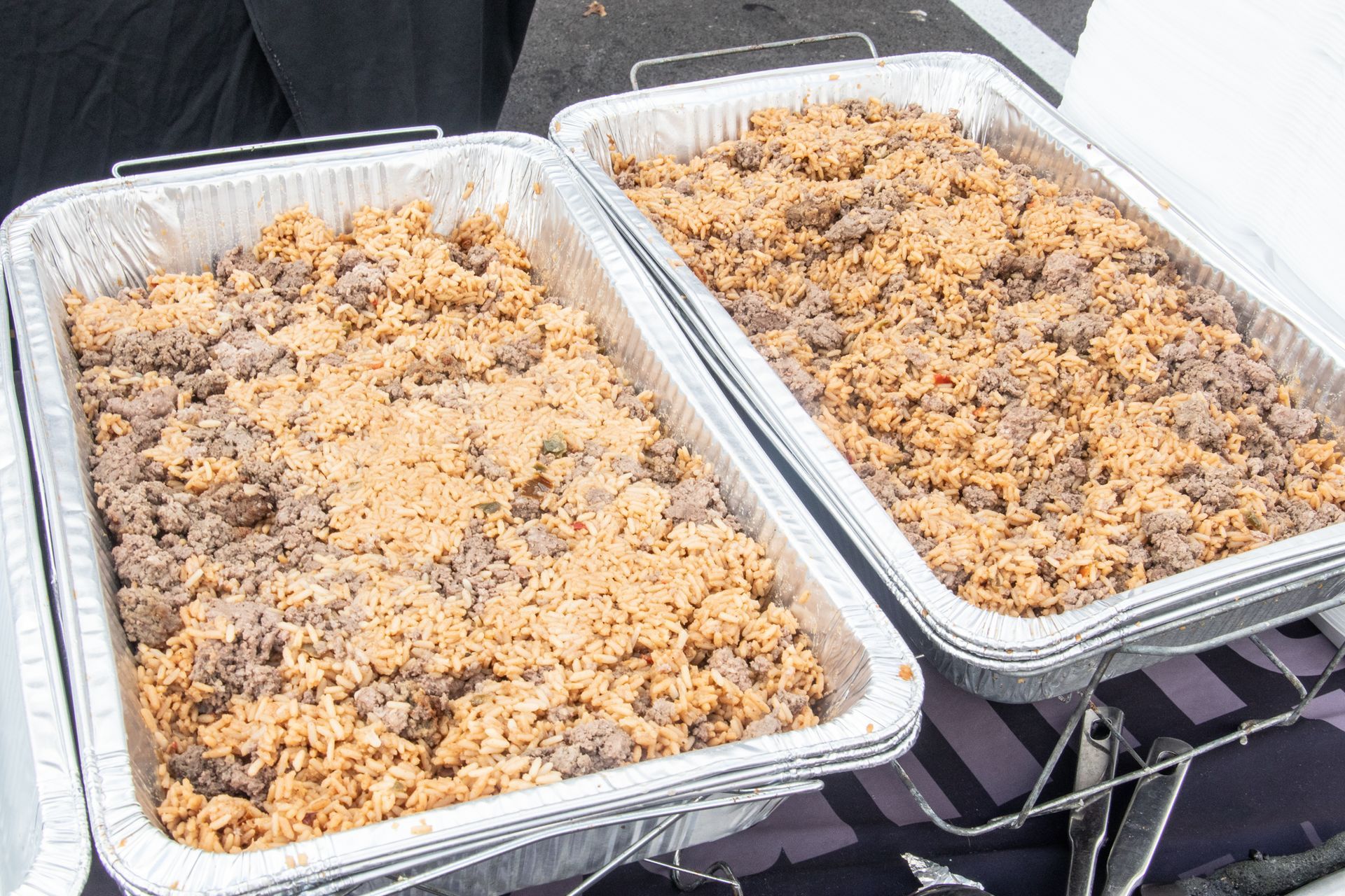 Two trays of food are sitting on a table.