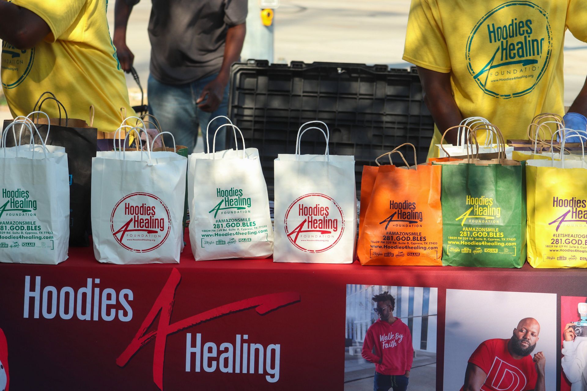 A table with hoodies and healing bags on it