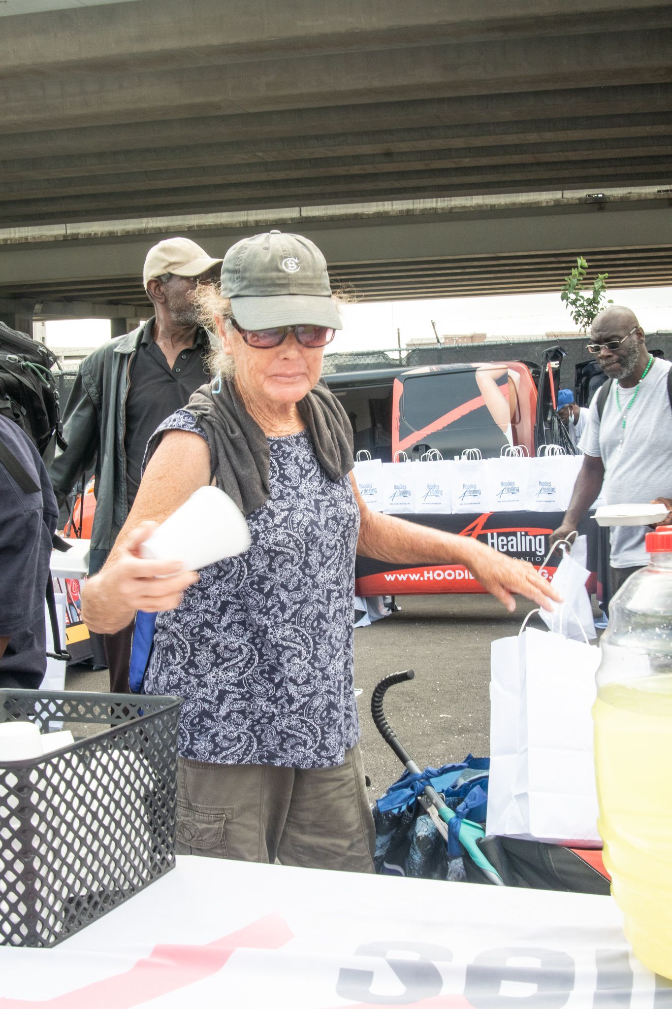A woman standing in front of a table with a sign that says kansas on it