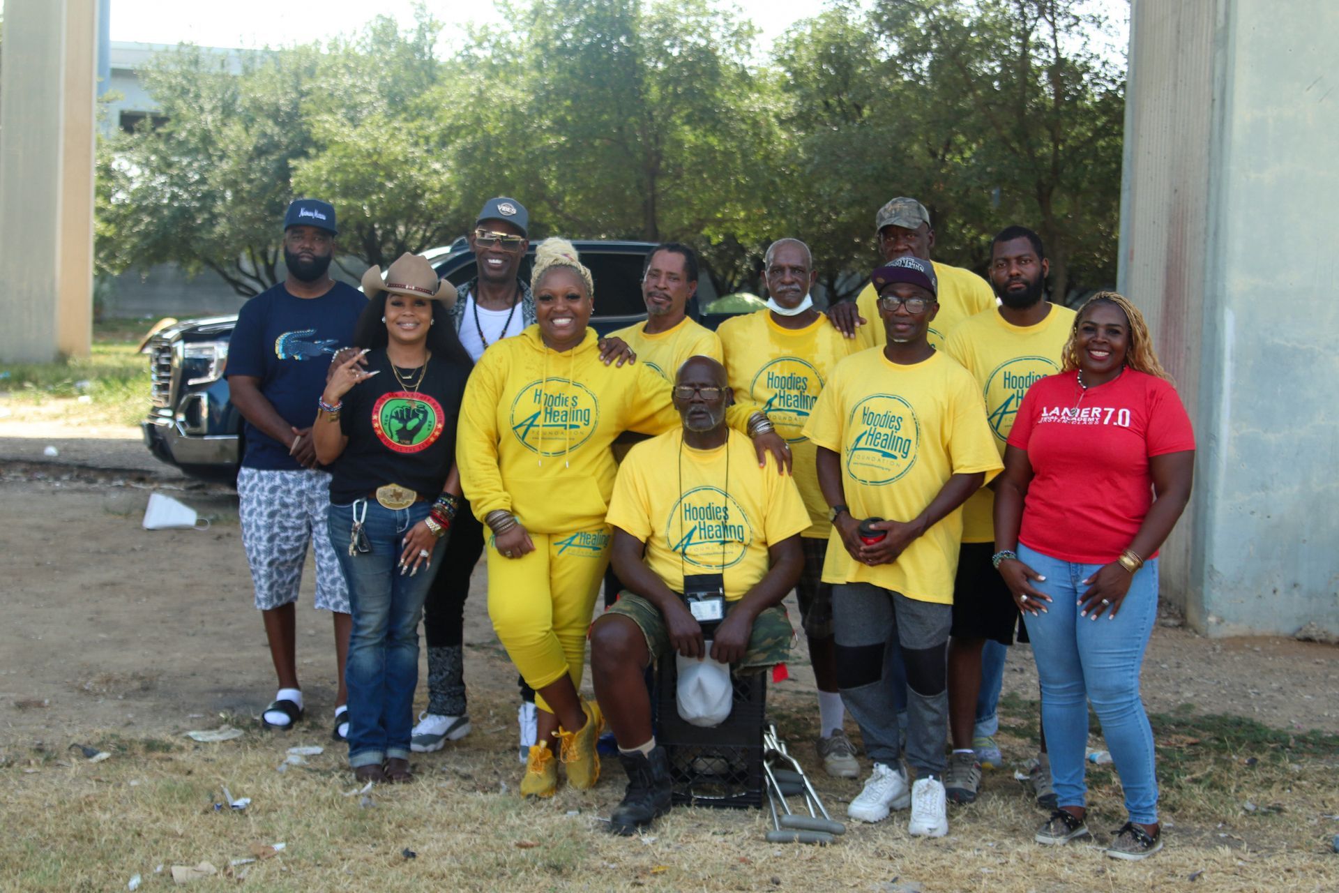 A group of people wearing yellow shirts are posing for a picture.