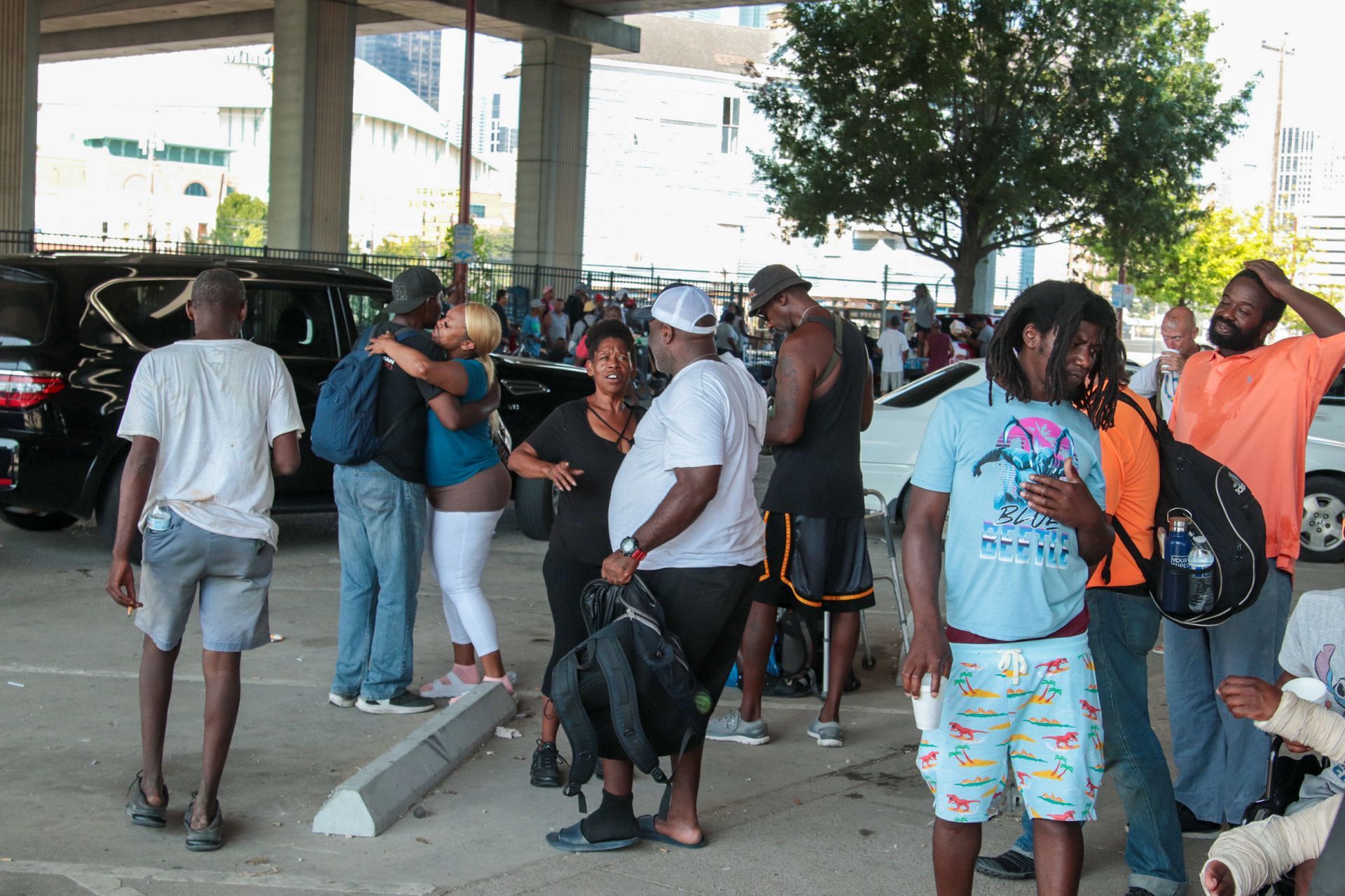 A group of people are standing in a parking lot