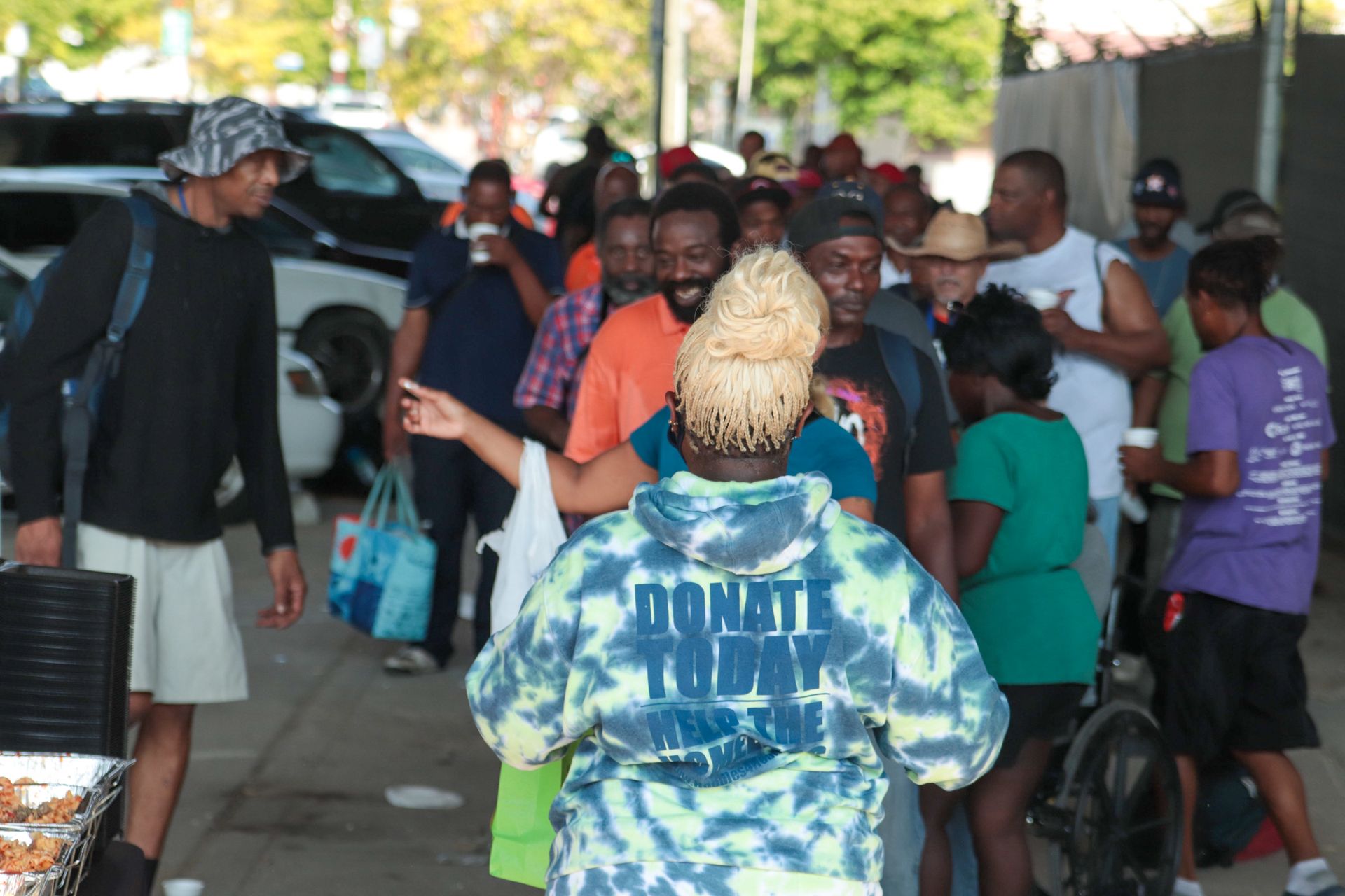 A woman wearing a hoodie that says donate today