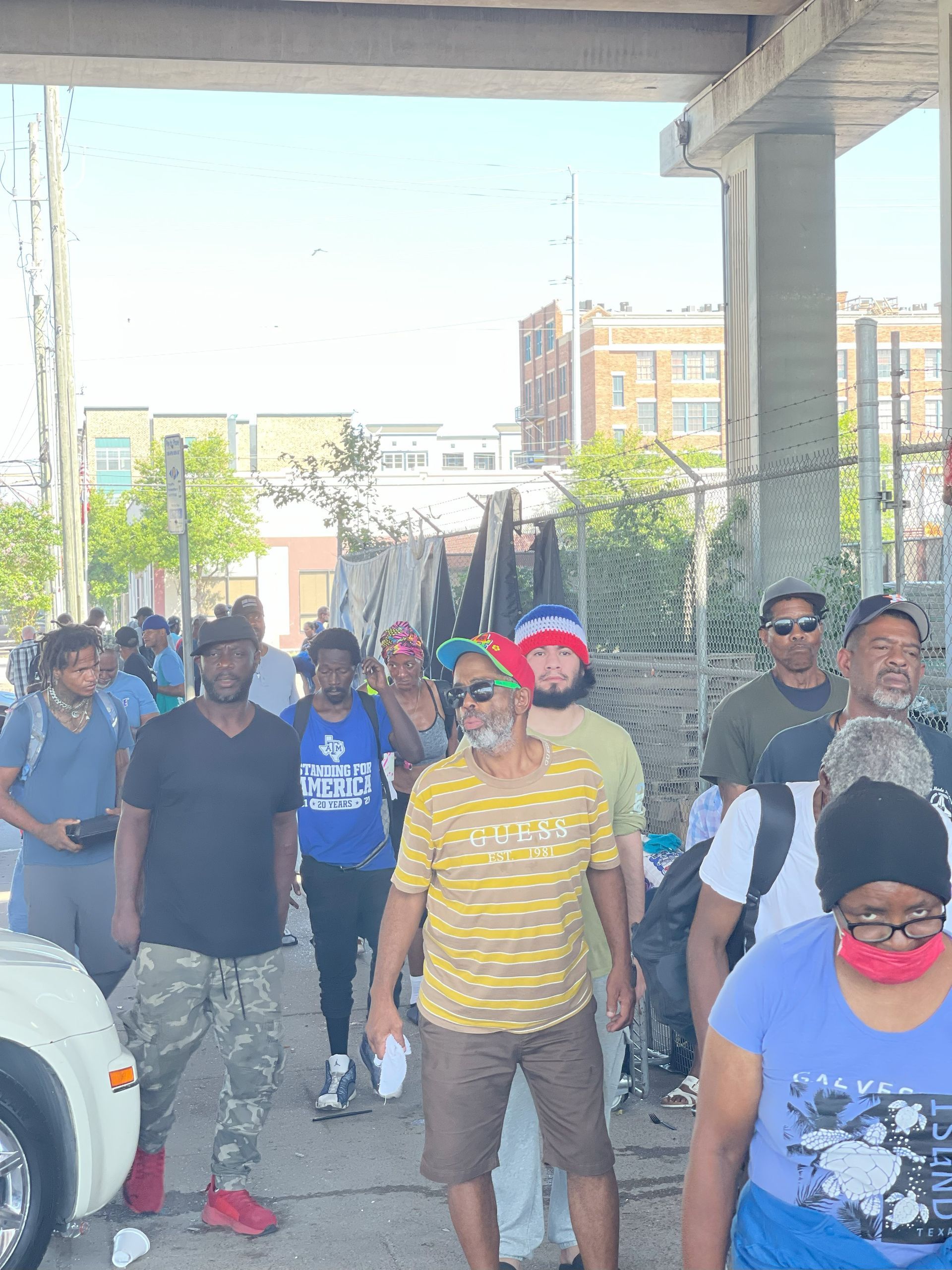A group of people are walking down a street.