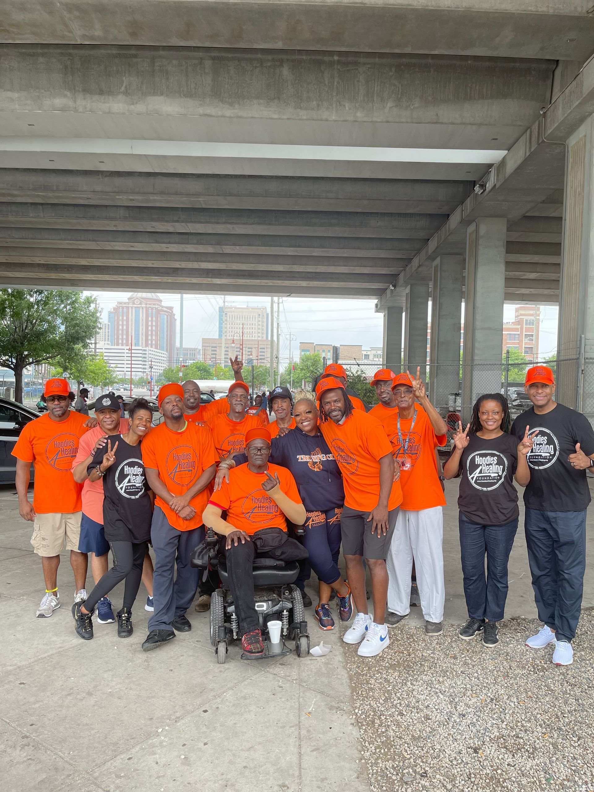 A group of people posing for a picture with one man in a wheelchair