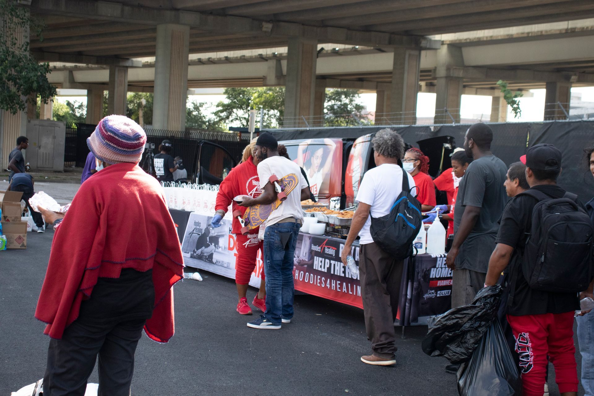 A group of people are standing around a table that says ' keep the faith ' on it