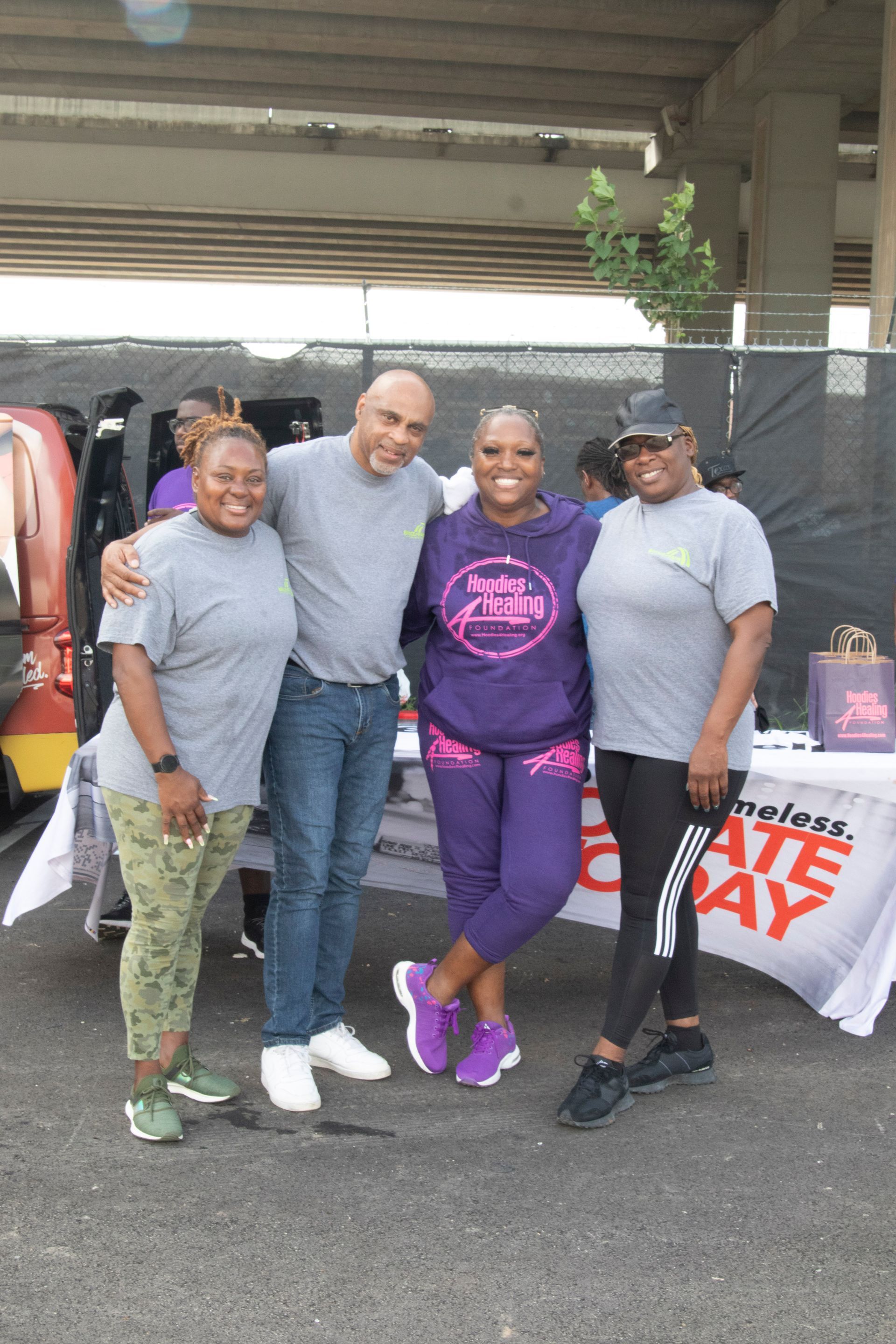 A group of people are posing for a picture in front of a table.