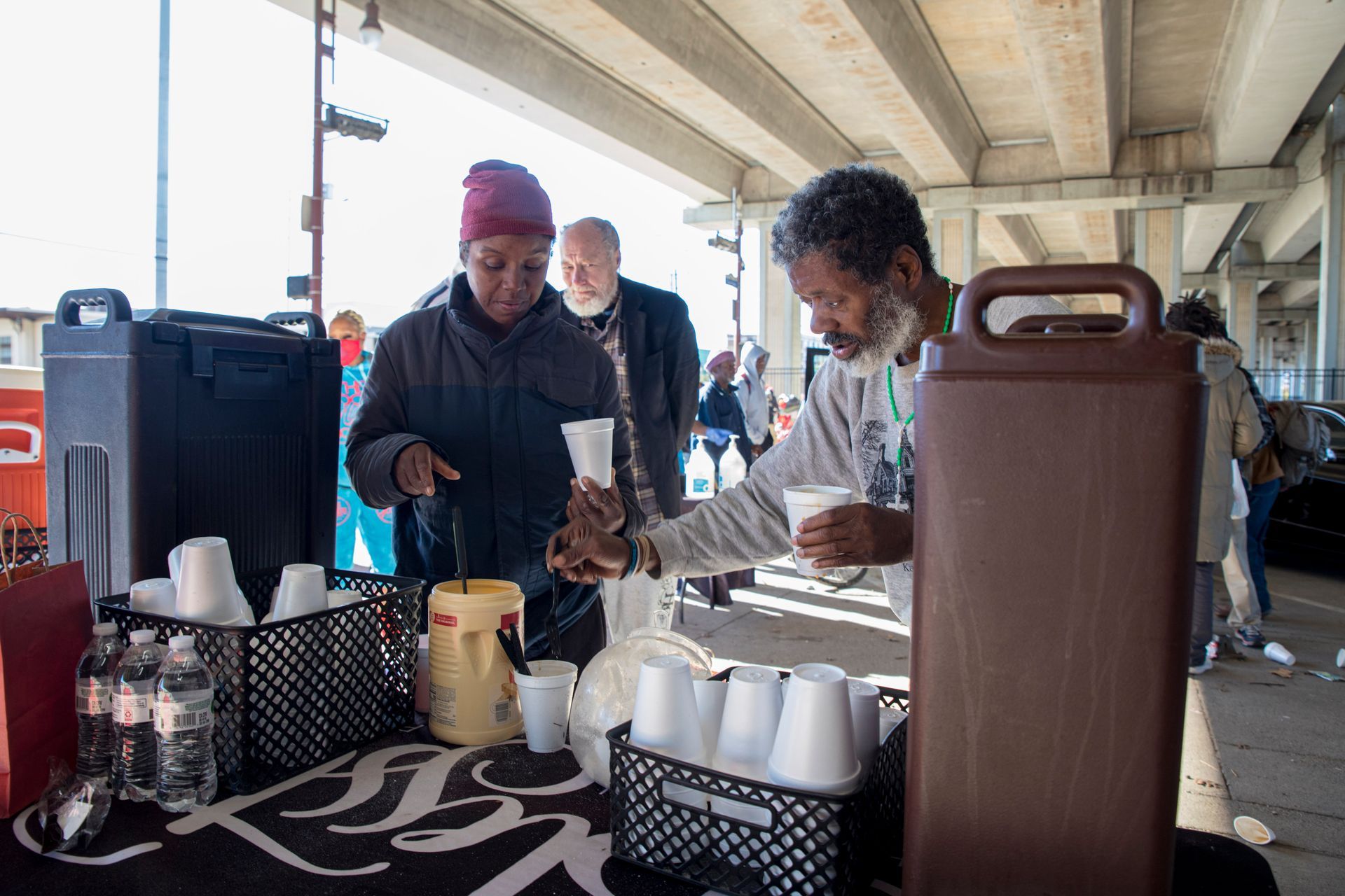 A man is serving a woman a cup of coffee.