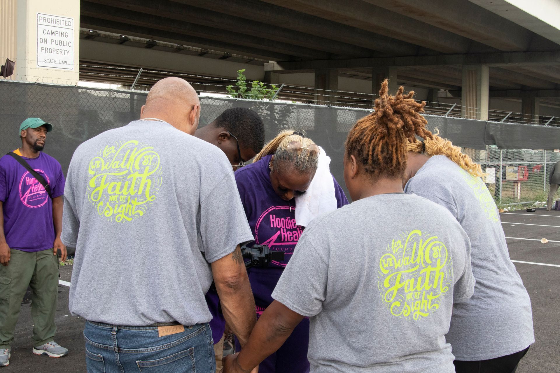 A group of people wearing grey shirts with the word faith on them