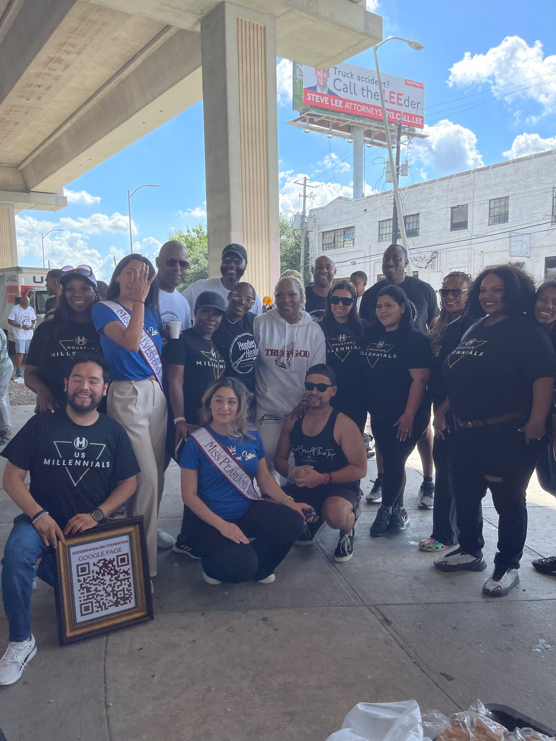 A group of people are posing for a picture in front of a building.