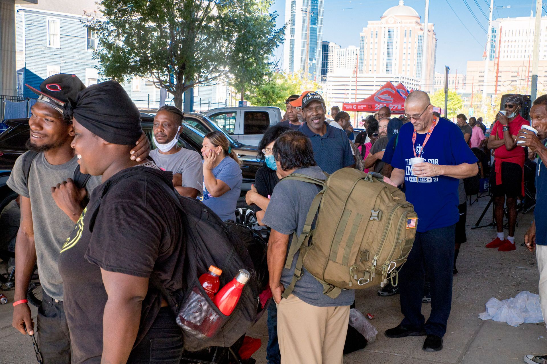 A group of people are standing in a parking lot.