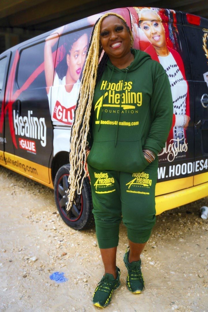 A woman wearing a green hoodie with the word healing on it