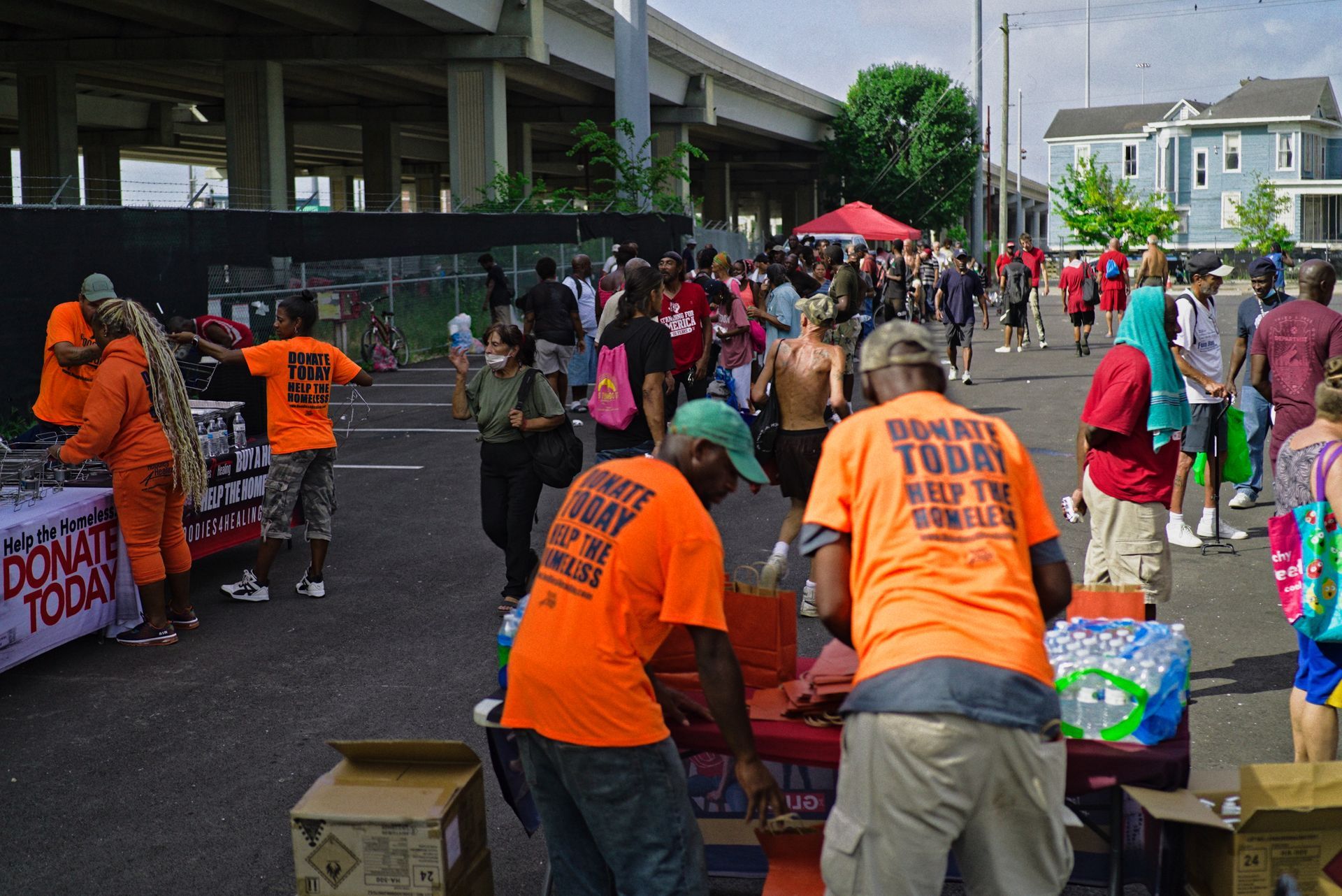 A group of people wearing orange shirts that say donate today