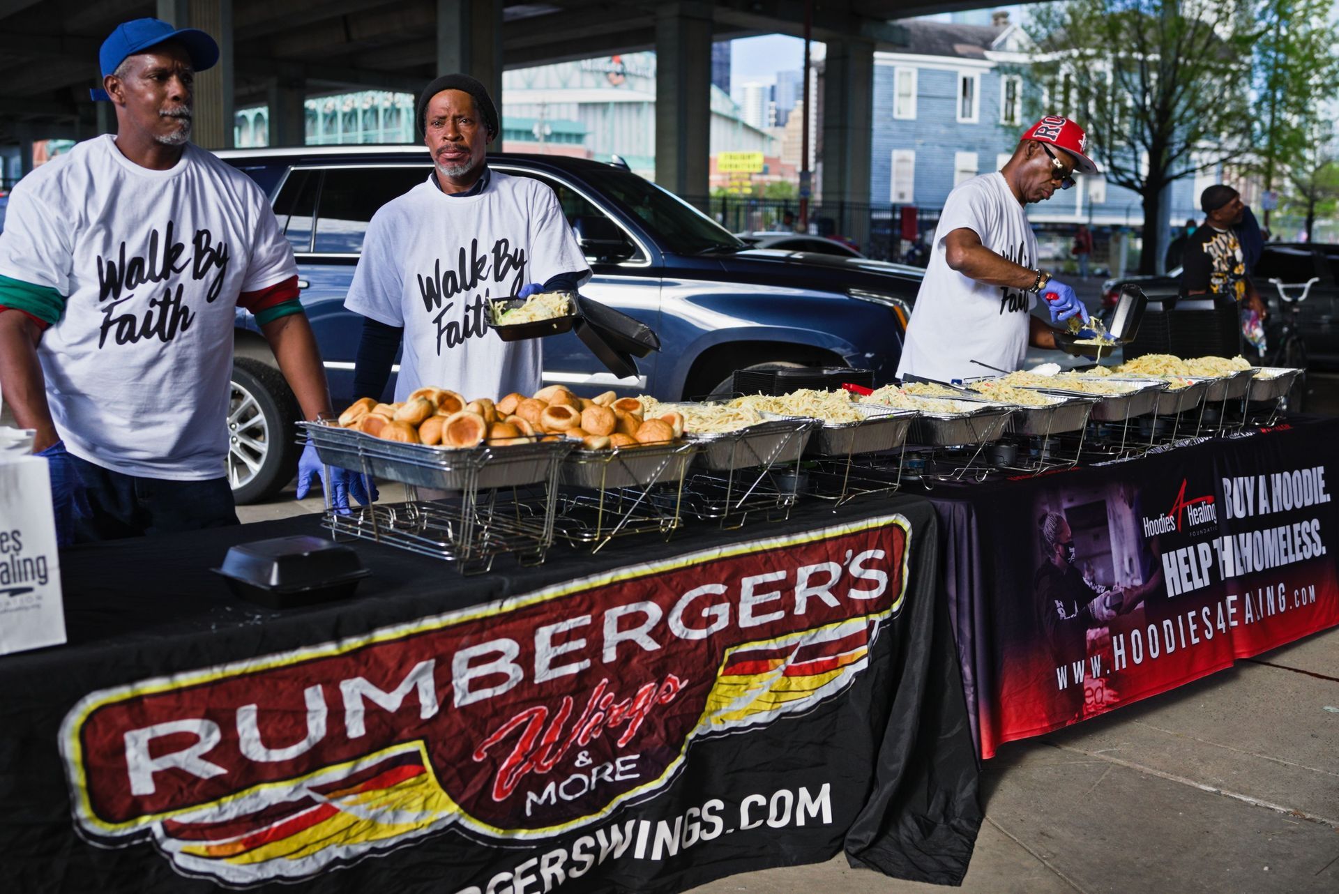 A group of people standing around a table that says rumberger 's