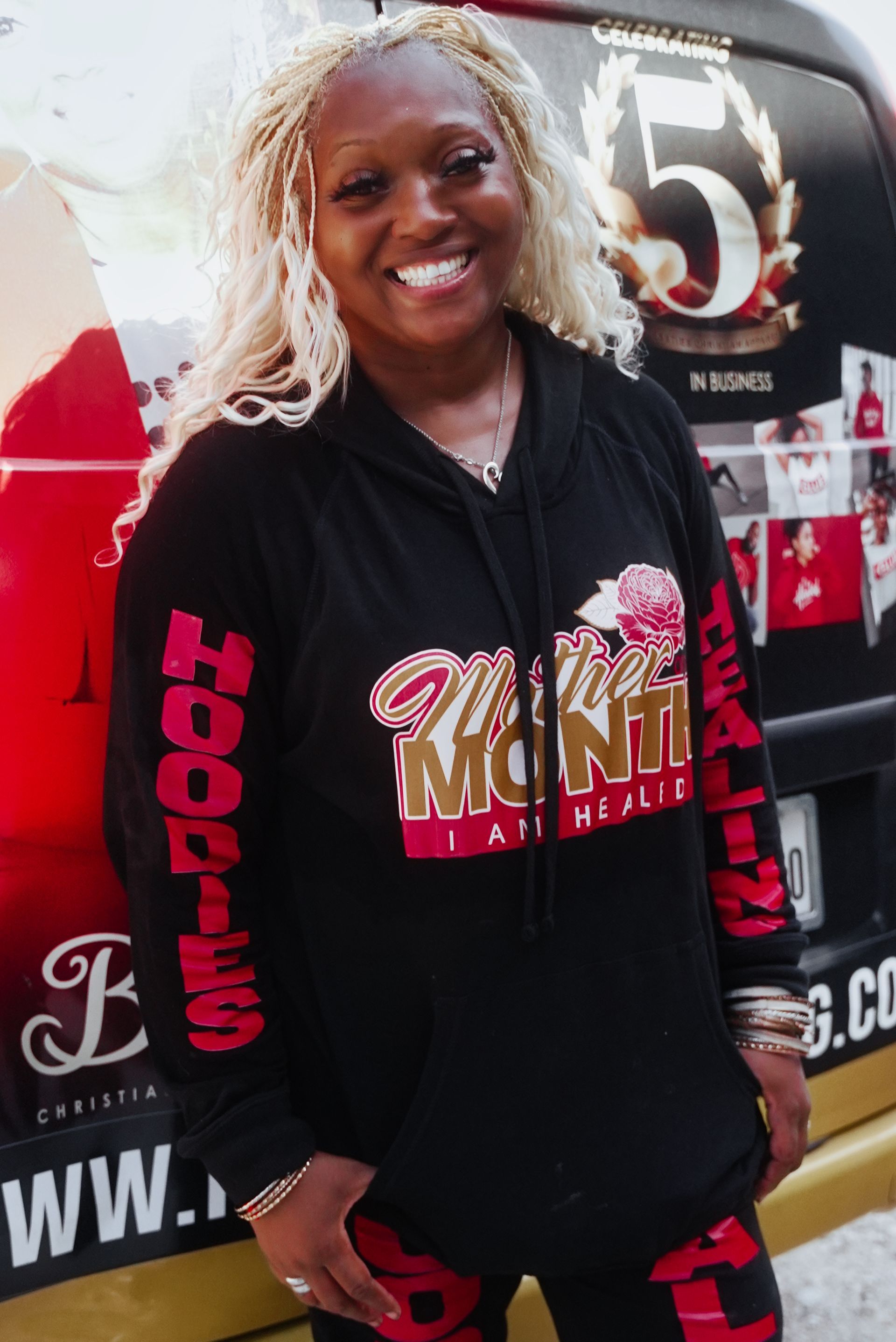 A woman wearing a black hoodie with the word monti on it
