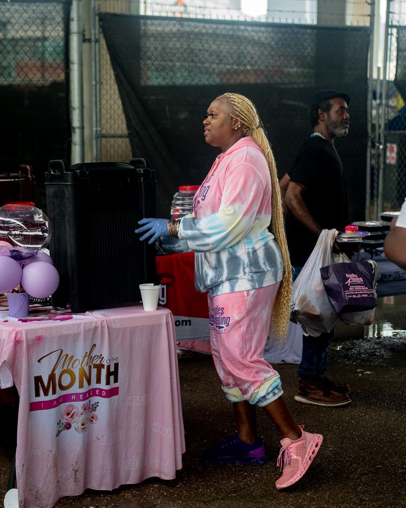 A woman is standing in front of a table that says mother 's month