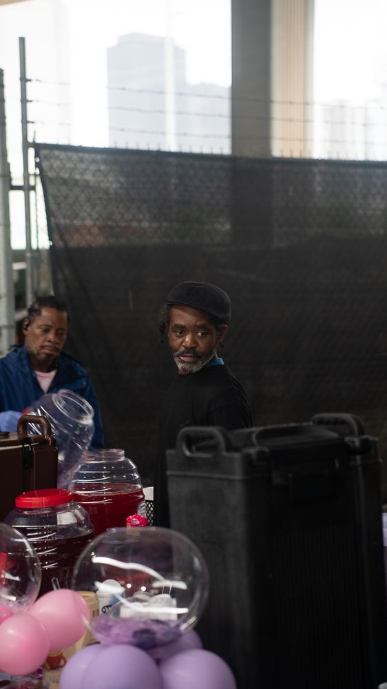 A man is standing in front of a table with balloons.