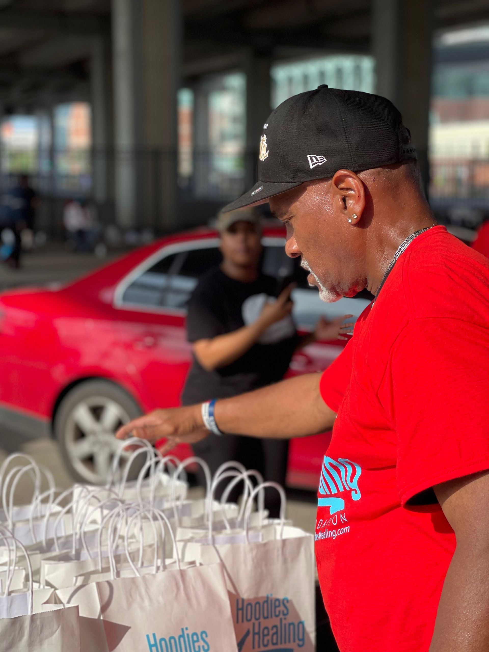 A man in a red shirt with the word hoodies on it