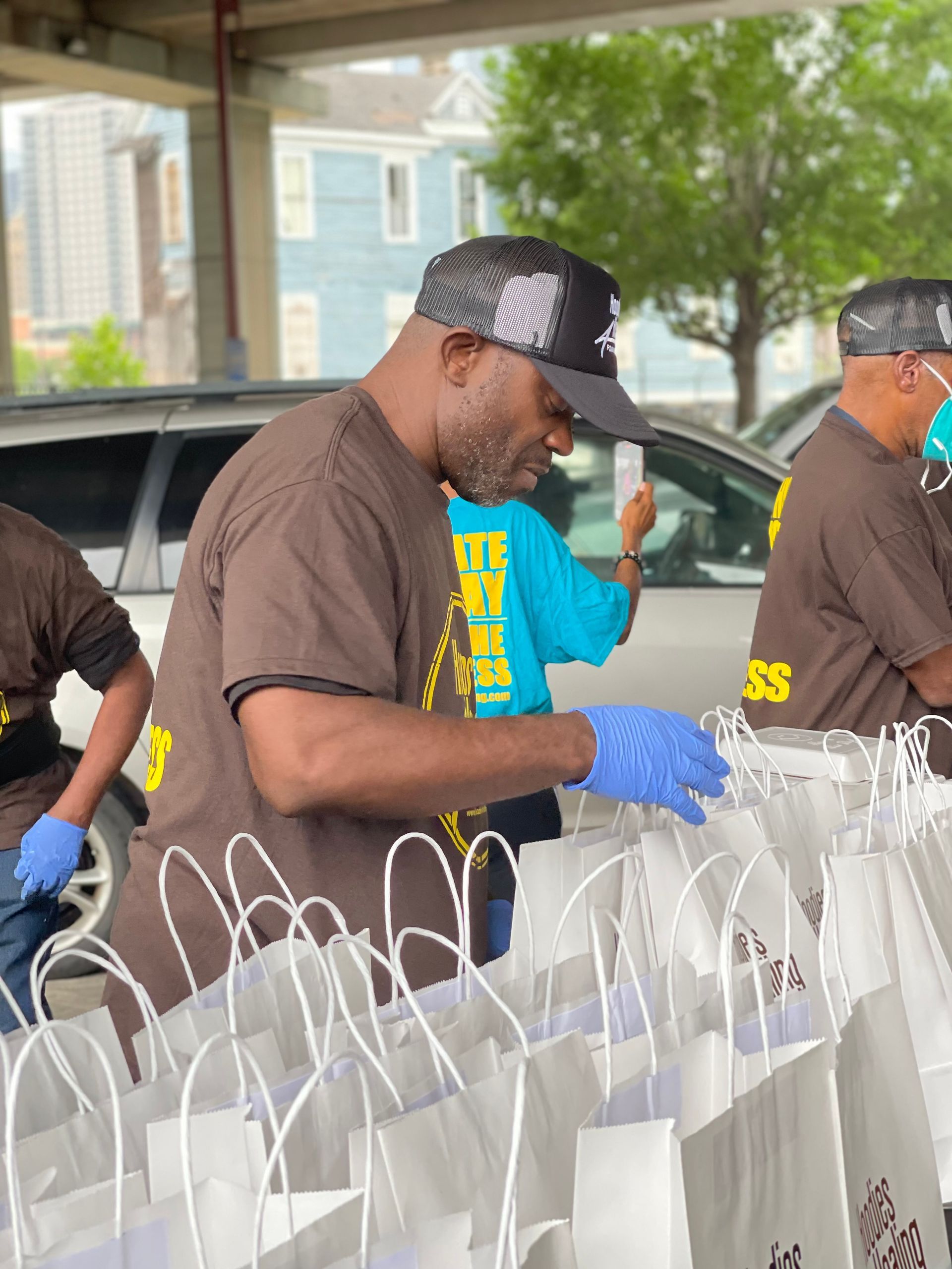 A group of men are working on a row of bags.
