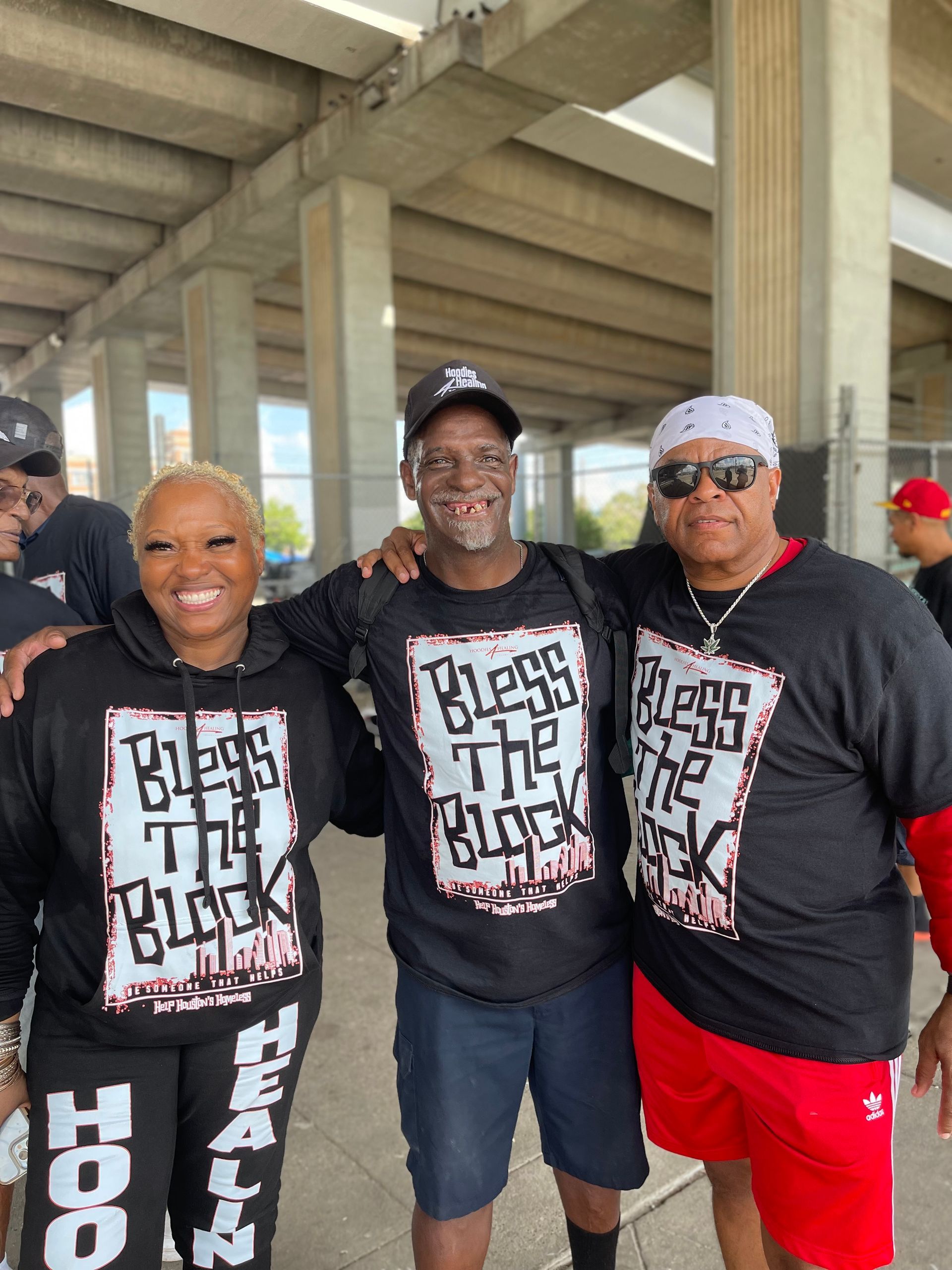 A group of people wearing black shirts that say bless the black