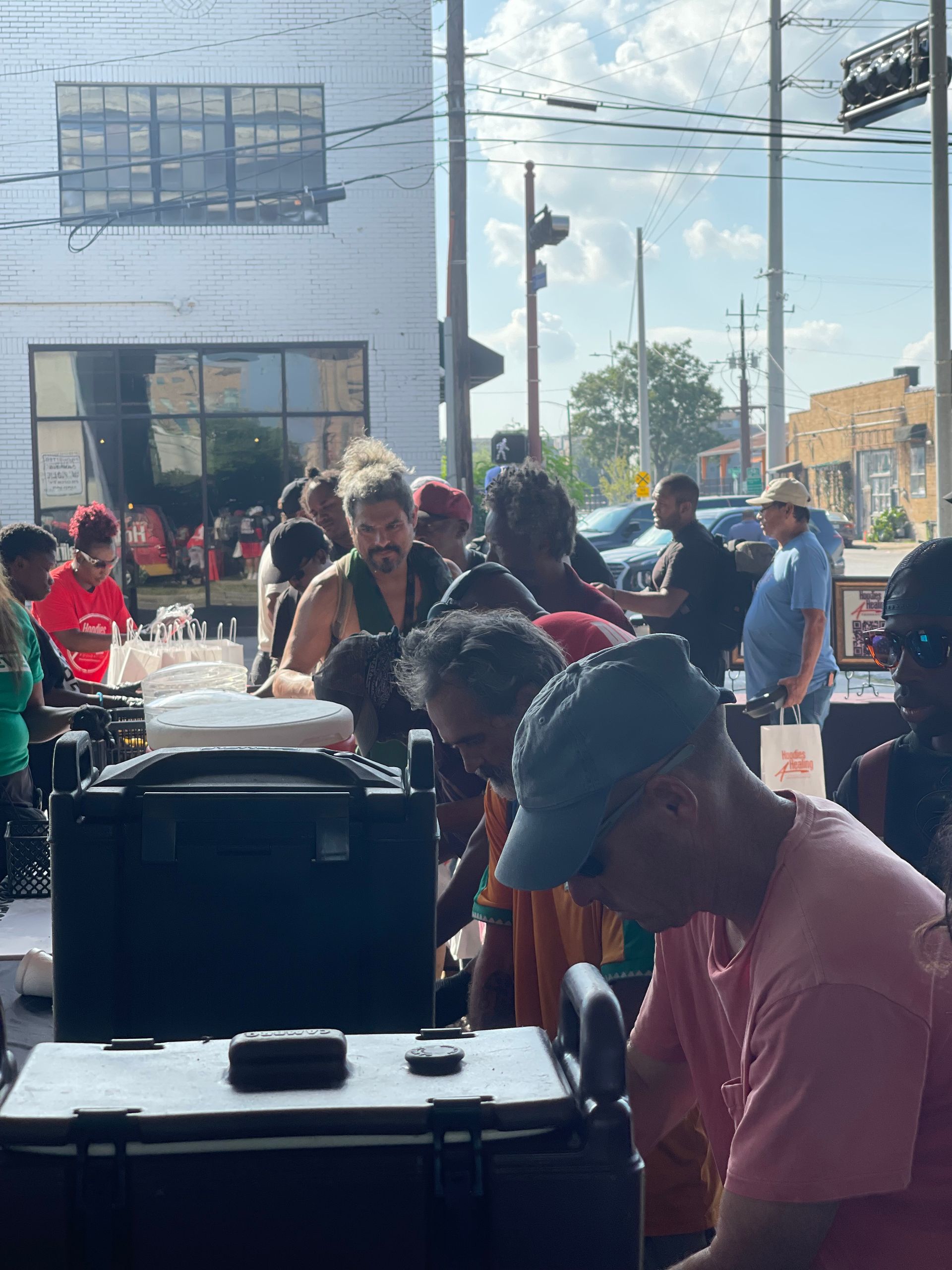 A group of people are gathered outside of a building