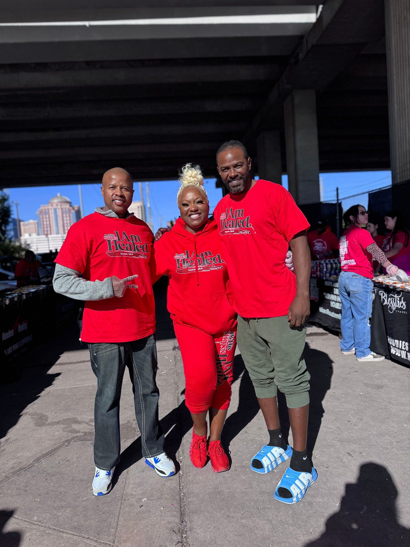 A group of people wearing red shirts are posing for a picture.