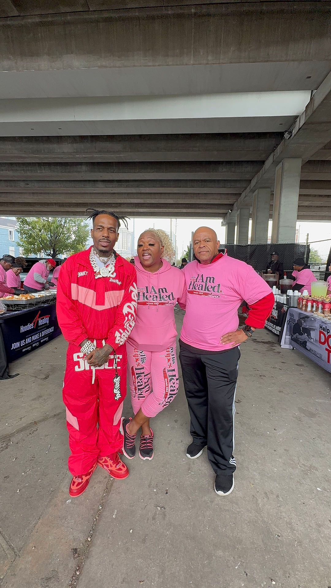 A group of people standing next to each other in a parking lot.