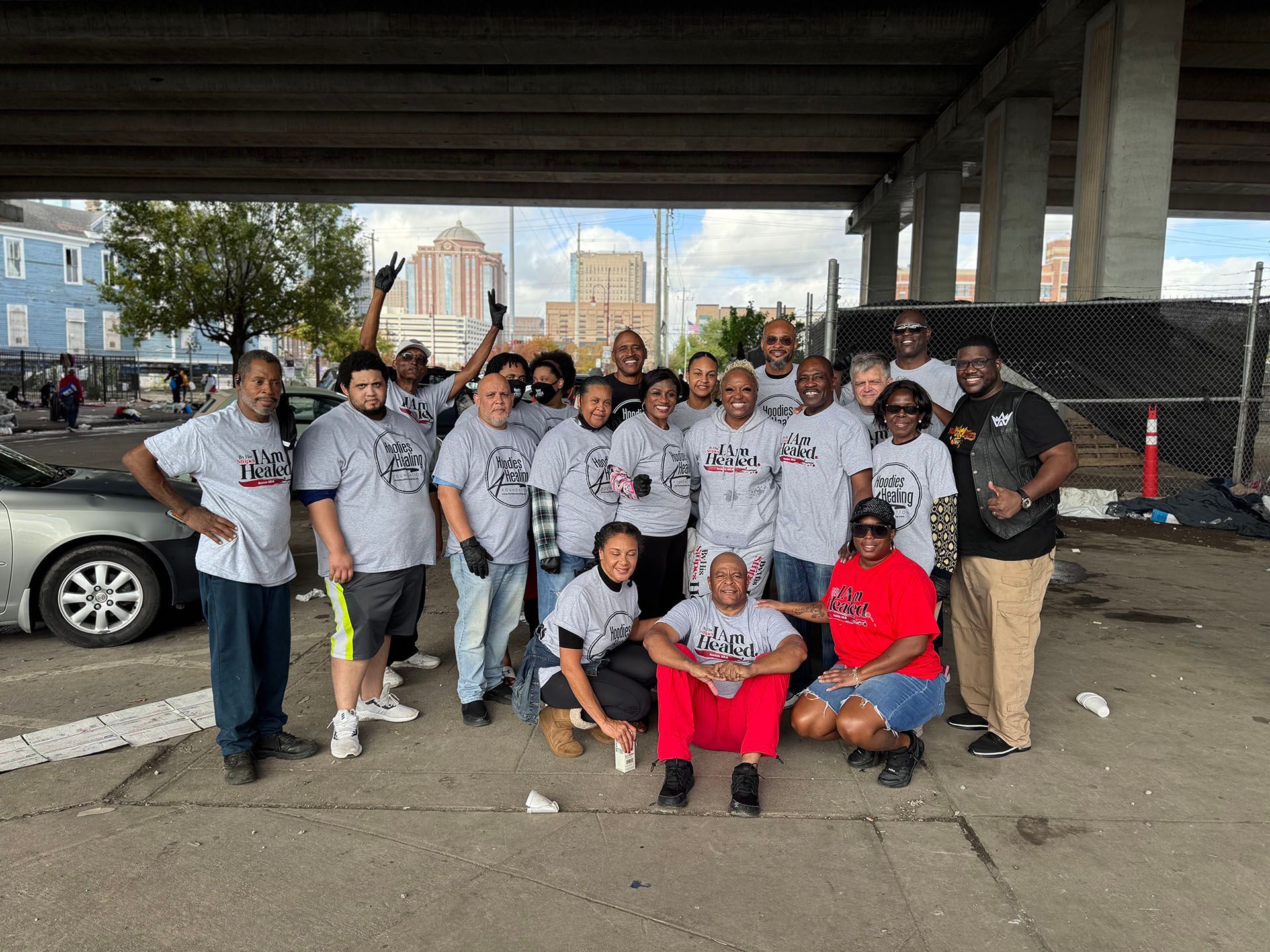 A group of people are posing for a picture under a bridge.