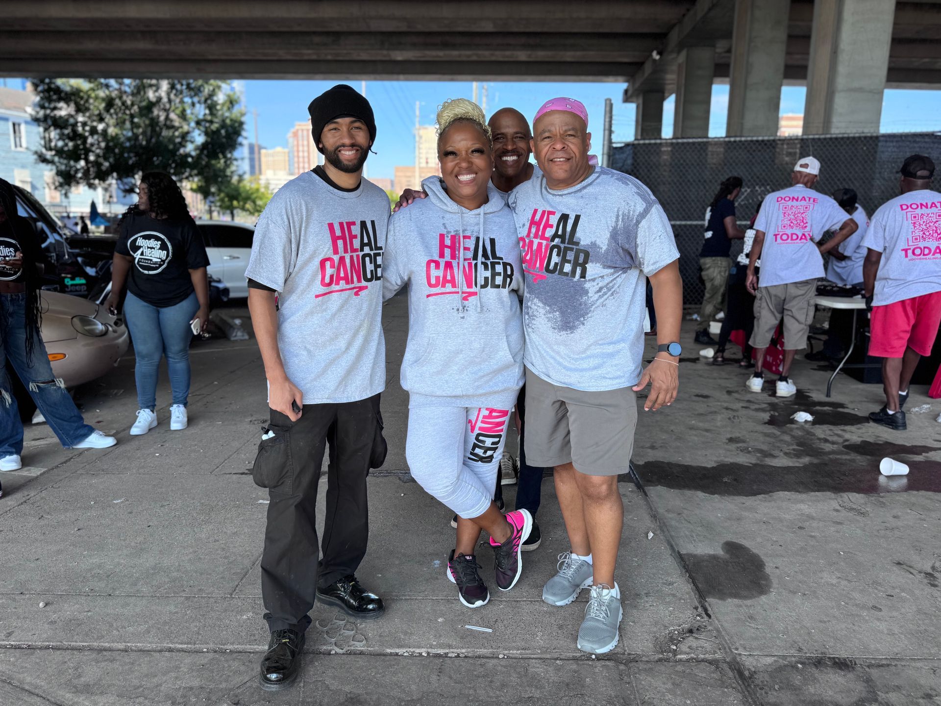 A group of people wearing shirts that say heal cancer are posing for a picture.