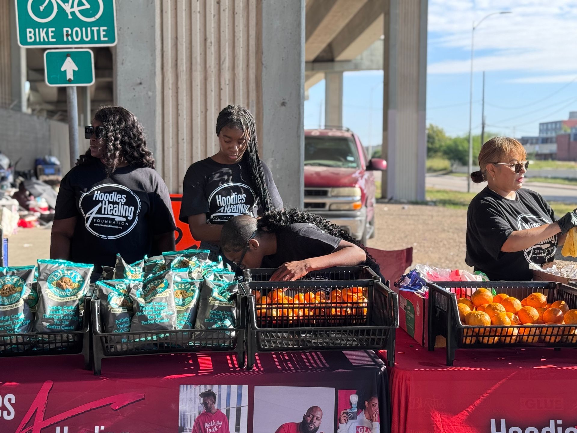 A group of people standing around a table with a sign that says bike route
