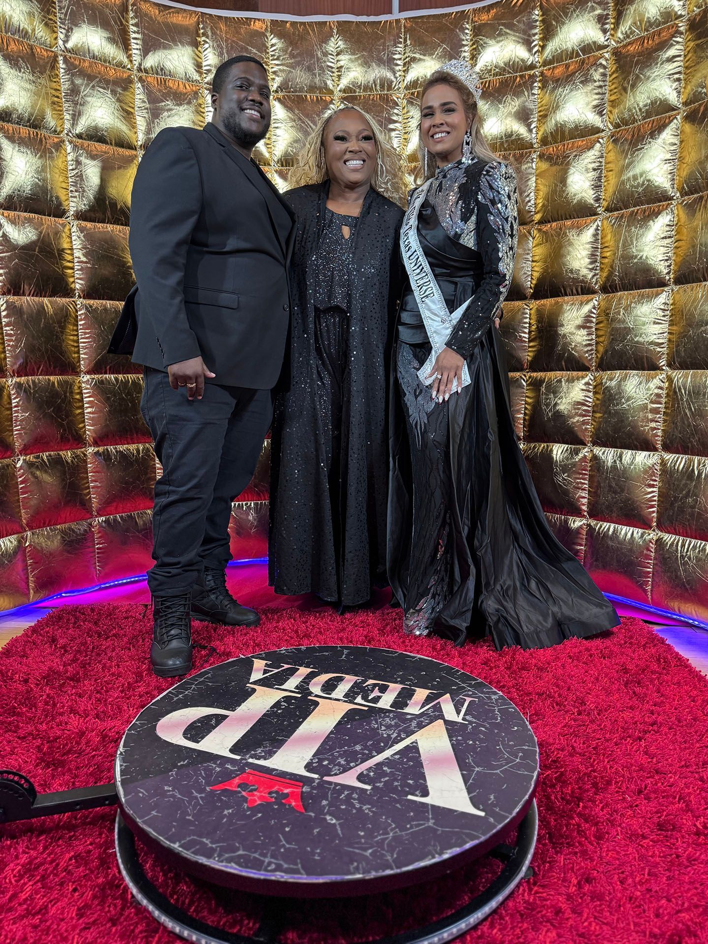 A man and two women are posing for a picture in a photo booth.