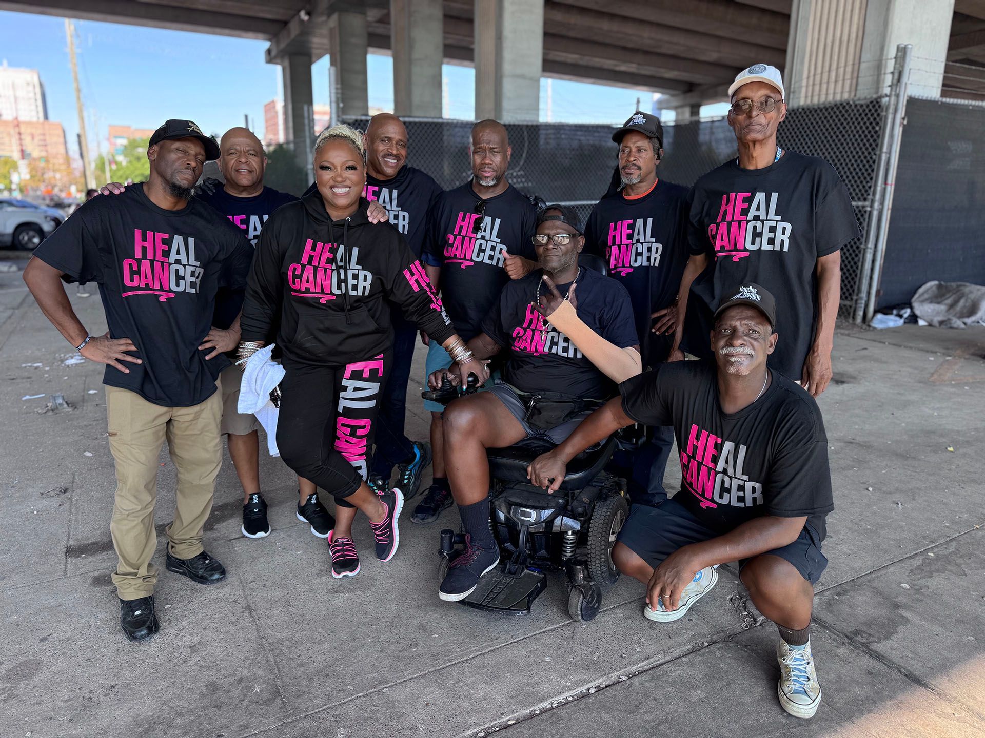 A group of people wearing shirts that say heal cancer are posing for a picture.