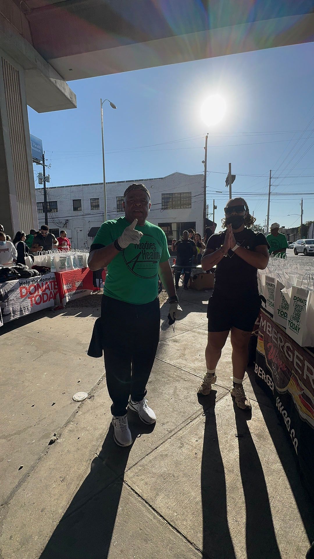 A man and a woman are walking down a sidewalk.