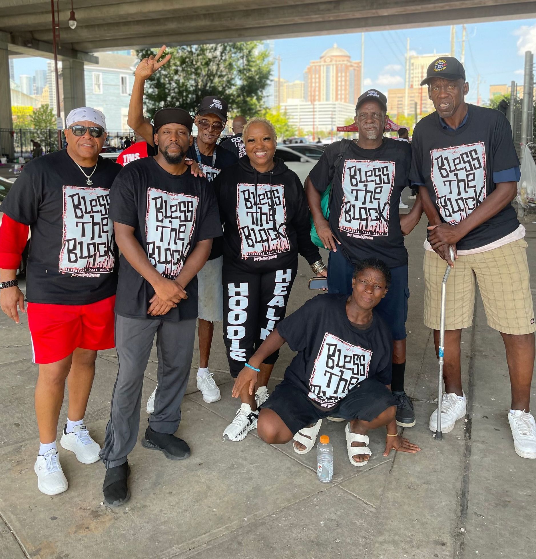 A group of people wearing t-shirts that say bless the black hoodie