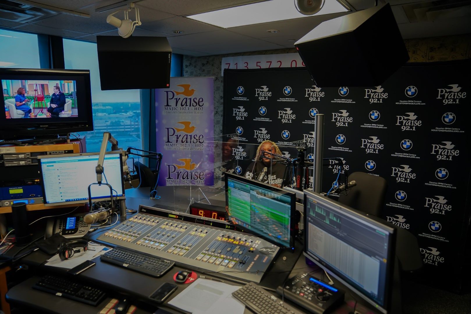 A room with a lot of computer monitors and a sign that says praise