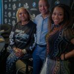 A group of people are posing for a picture in a room.