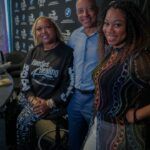 A group of people are posing for a picture in a room.