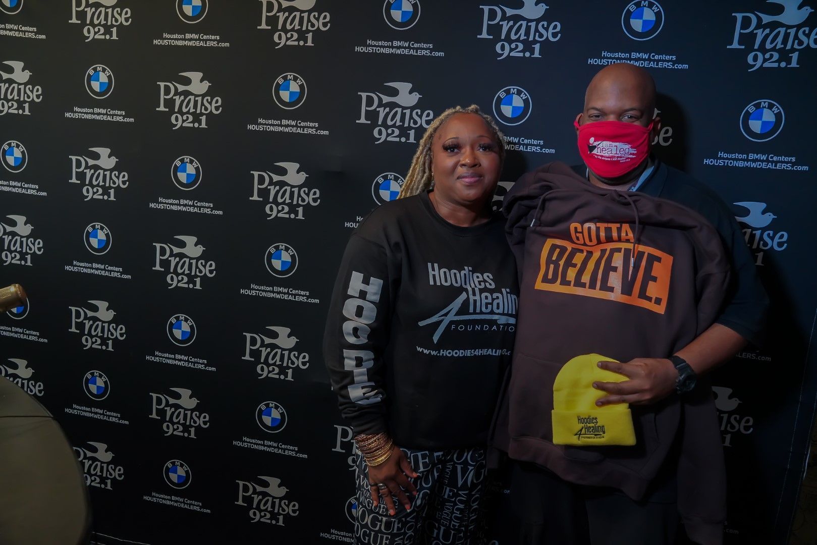 A man and a woman wearing face masks are posing for a picture.