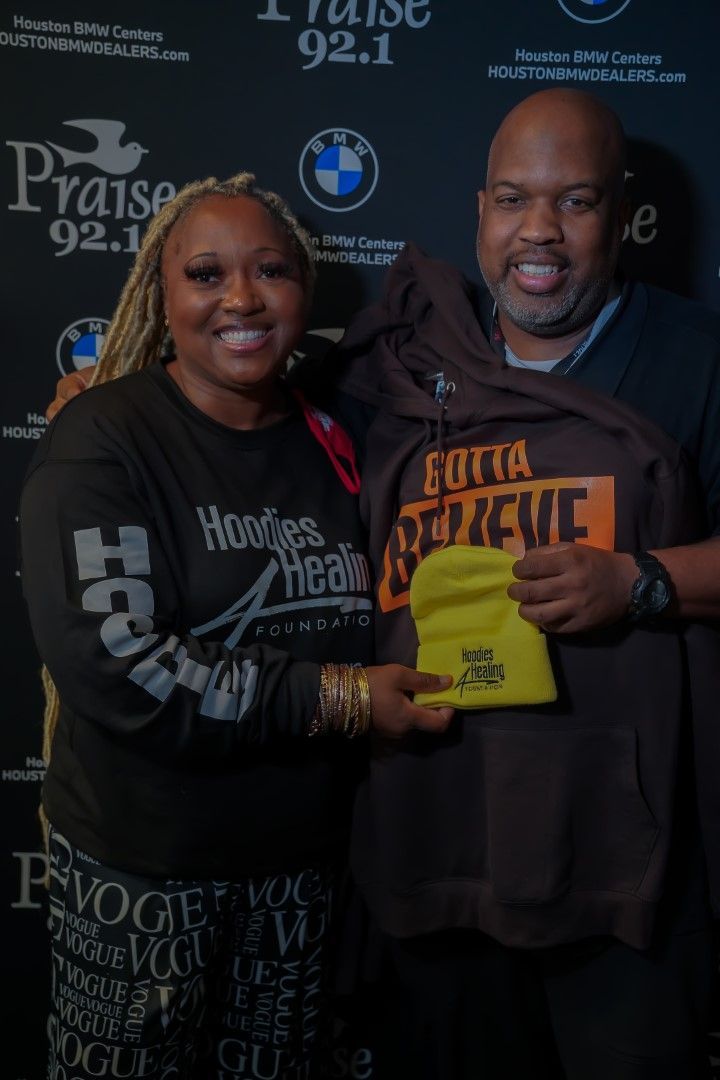 A man and a woman are posing for a picture and the woman is wearing a shirt that says gotta believe