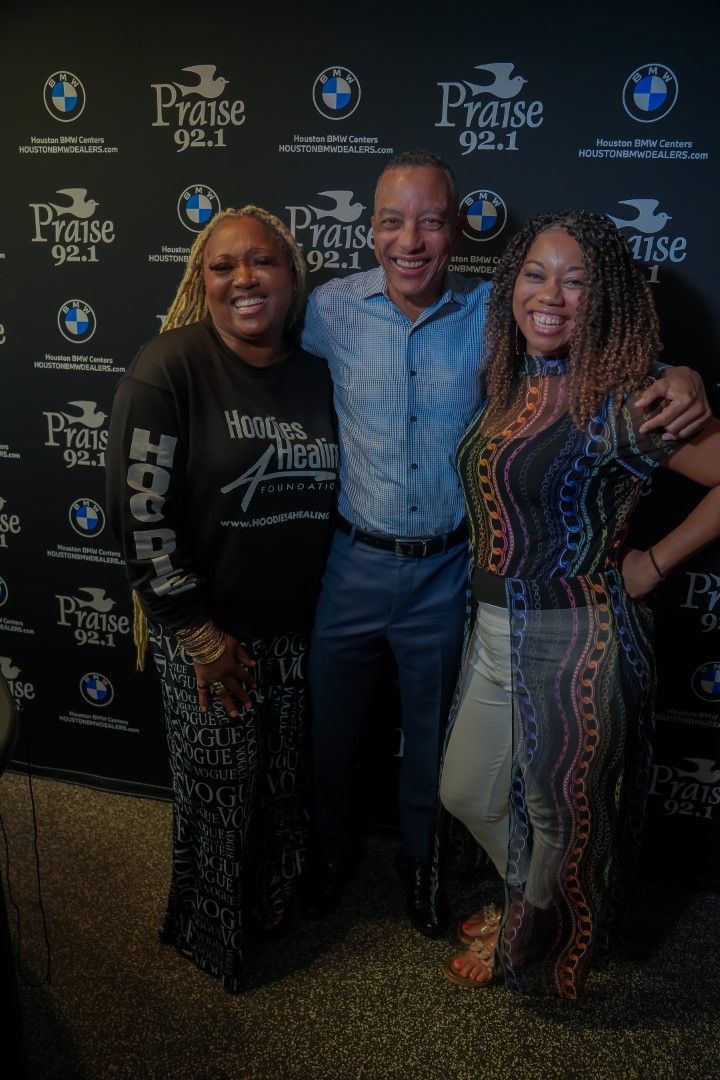 A man and two women are posing for a picture.