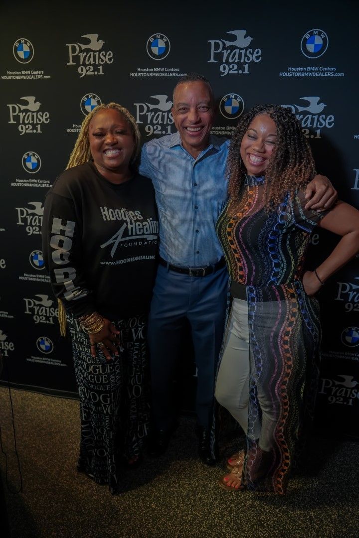 A man and two women are posing for a picture.