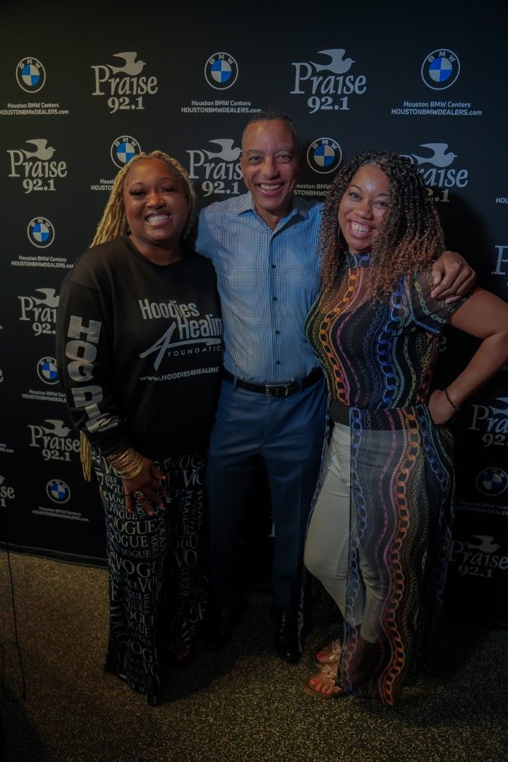 A man and two women are posing for a picture.