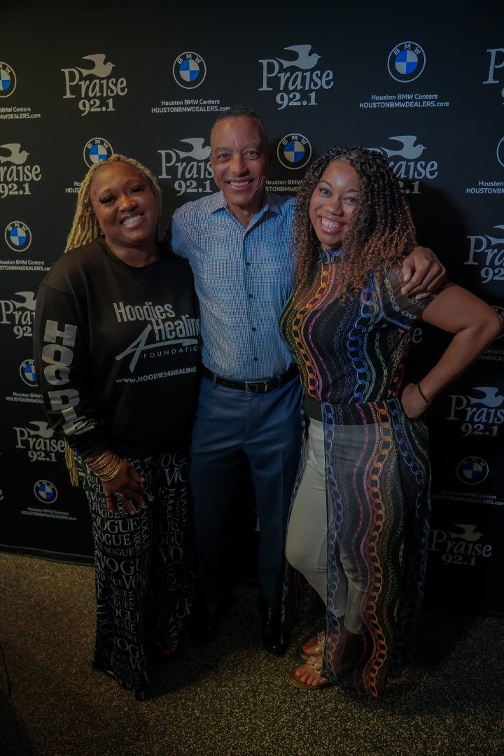 A man and two women are posing for a picture.