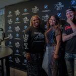 A group of people are standing in front of a blackboard.