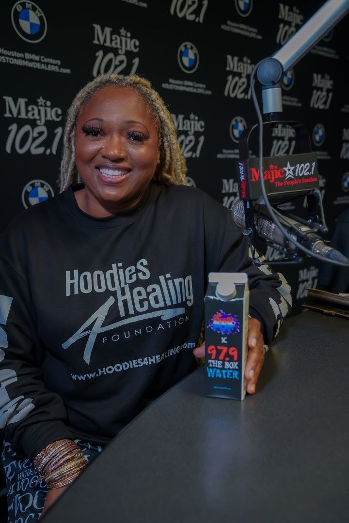 A woman wearing a hoodie that says hoodies healing