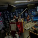 A person is sitting at a desk in a radio station.