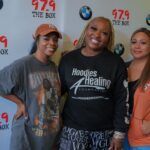 A group of women are posing for a picture on a red carpet.