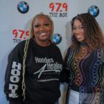 Two women are posing for a picture together on a red carpet.